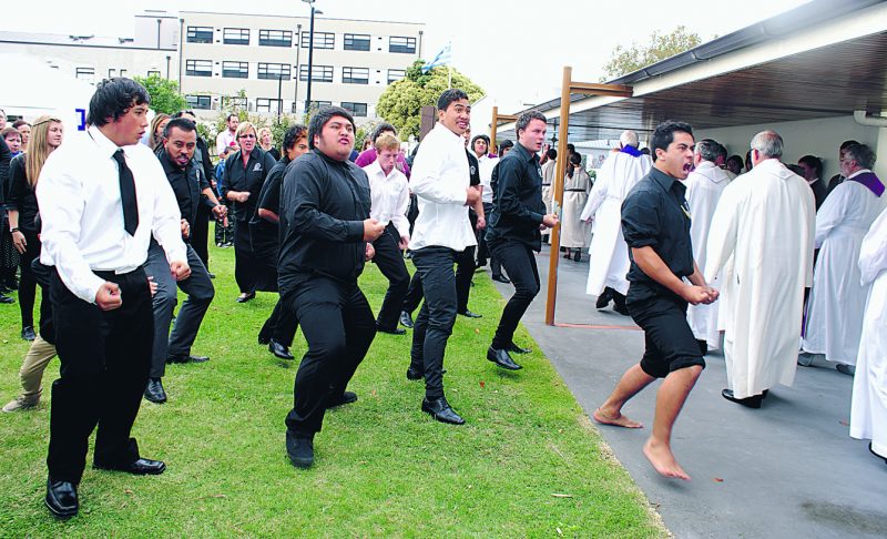 Young people from the Challenge 2000 Youth Development Agency perform a haka as Msgr Tim Hannigan's coffin is taken from St Patrick's Church, Napier.