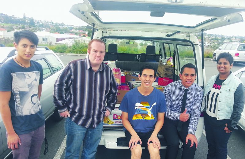 Andrew Quirke (second from left) and Tutangata Ama (fourth from left) with other Christ the King helpers pack the van with food. Tutangata is also a Tertiary Vinnie.