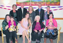 Moira Carew surrounded by three generations of her family on the occasion of her 100th birthday at Milford, Auckland.