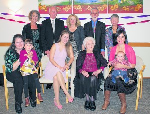 Moira Carew surrounded by three generations of her family on the occasion of her 100th birthday at Milford, Auckland.