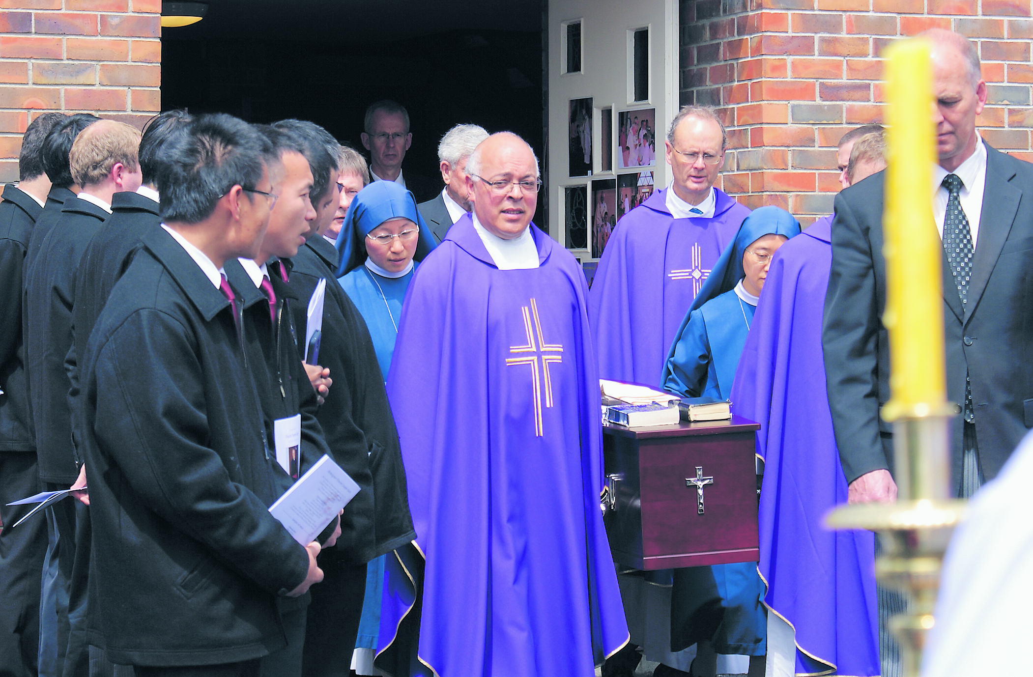 Seminarians from Holy Cross Seminary form a guard of honour as the casket of Msgr Vincent Hunt (inset) is carried out of Sacred Heart Church in Ponsonby on October 13. The Salve Regina was sung after the casket was placed in the hearse.