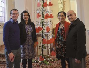 Simone and Shane Olsen, and Simone’s parents, Jackie and Amy Jansen, stand by the “I Love You” tree in Sacred Heart Basilica in Wellington.