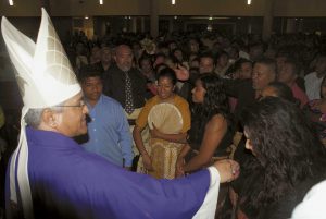 Cardinal Soane Mafi ’s hand is kissed as a vast crowd surrounds him after Mass waiting to receive his blessing.