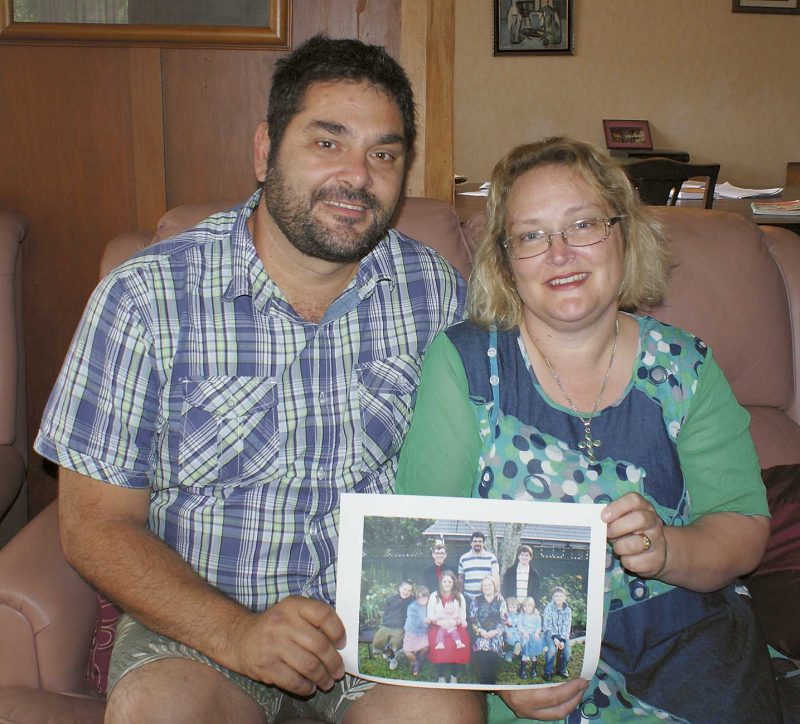 Michael and Rebecca
Loretz hold a photo
of all the family,
including “miracle
baby” Philomena.