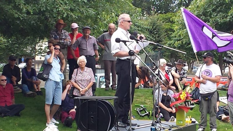 Bisop Charles Drennan speaks before the protesters against the Trans Pacific Partnership Agreement at The Square in Palmerston North.
