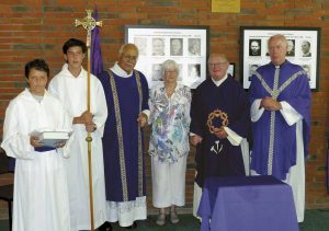 From left, with the images: altar servers Alfonso Mackinnon and Br Josemaria Mackinnon, Deacon Haumaha, parishioner Kathleen White, Emeritus Bishop Denis Browne, parish priest Fr Vincent Jones.