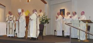 Bishop Denis Browne is warmly applauded at the end of a Mass honouring his 20 years of episcopal service in Hamilton diocese.