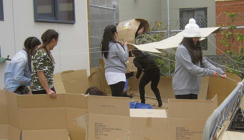 Students from Marian College and Cathedral College build their shelter for the night.