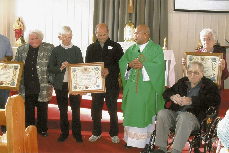Three certificates of blessing for three couples are apparent. From left to right, Kay  Spillane, Bib and Basil Grbic, Fr Dujali, Yvonne
and Murray Dickson. Mrs Spillane’s husband, Gavan, did  not live to enjoy the  occasion.