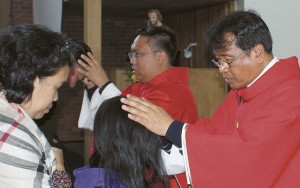 Frs Brazil (left) and Guleng bless people at Good Shpeherd Church after Mass.