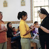 Franciscan sister distributes Communion during weekday Mass at St. Peter Indian Mission School in Arizona