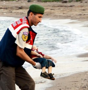 A member of the Turkish military carries a young migrant Sept. 2, who drowned in a failed attempt to sail to the Greek island of Kos, in the coastal town of Bodrum, Turkey. A Turkish media report says at least 11 migrants have died and five others are missing after boats carrying them to the Greek island of Kos capsized. (CNS photo/Reuters) Editors: Be advised of graphic content. Editorial use only.
