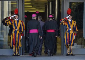 Bishops arrive at the Synod on the Families, in the Synod Aula, at the Vatican, on October 6, 2014. The Pontiff on Sunday launched a major review of Catholic teaching on the family that could lead to change in the Church's attitude to marriage, cohabitation and divorce. An extraordinary synod, or meeting, of nearly 200 bishops from around the world and a sprinkling of lay people will, for the next two weeks, address the huge gulf between what the Church currently says on these issues and what tens of millions of believers actually do.   AFP PHOTO / ANDREAS SOLARO        (Photo credit should read ANDREAS SOLARO/AFP/Getty Images)