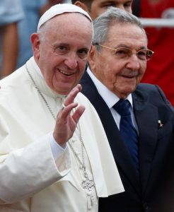 Pope Francis waves as he walks with Cuban President Raul Castro at Jose Marti International Airport in Havana Sept. 19. (CNS photo/Paul Haring) See POPE-CUBA-ARRIVE Sept. 19, 2015.