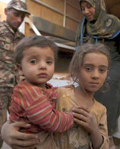Syrian refugee children covered with dust arrive Sept. 10 at the Jordanian border with Syria and Iraq, near the town of Ruwaished, which is close to Amman, Jordan. (CNS photo/Muhammad Hamed, Reuters) See SYRIAN-REFUGEES-KURTZ Sept. 11, 2015.