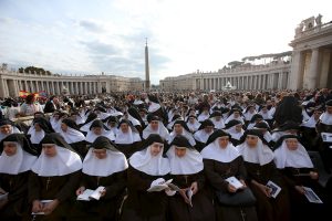 Nuns wait for Pope Francis to lead the Oct. 18 Mass for the canonization of four new saints in St. Peter's Square at the Vatican. Pope Francis canonized Spanish Sister Maria of the Immaculate Conception, a member of the Congregation of the Sisters of the Company of the Cross; Italian Father Vincenzo Grossi, founder of the Institute of the Daughters of the Oratory; and Louis and Marie Zelie Guerin Martin, the parents of St. Therese of Lisieux. (CNS photo/Alessandro Bianchi, Reuters) See POPE-SAINTS-SERVICE Oct. 19, 2015.