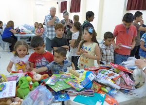 Iraqi refugee children choose gifts donated by New Zealand pilgrims.