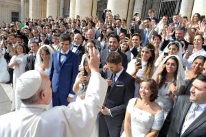 Pope Francis greets newly married couples during his general audience in St. Peter's Square at the Vatican Sept. 30. The pope said everyone has a guardian angel who advises and guides them throughout life. (CNS photo/L'Osservatore Romano) See POPE-MASS-GUARDIAN-ANGELS Oct. 2, 2015. EDITORS: For editorial use only.