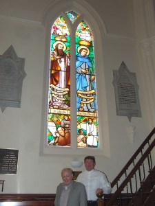 Window sponsor Fr  Patrick Collins and cathedral administrator Msgr Bernard Kiely beneath the new window.
