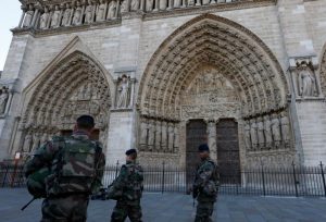 Soldiers pass the main entrance of Notre Dame cathedral in Paris Nov. 15. Sunday Masses were celebrated amid tight security outside the cathedral in the aftermath of Nov. 13 terrorist attacks in Paris that killed 129 and injured 352. (CNS photo/Paul Haring) See POPE-PARIS-TERROR Nov. 14, 2015 and PARIS-ATTACK-LOMBARDI Nov. 13, 2015.