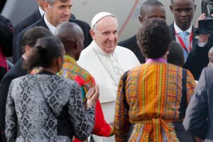 Pope Francis smiles as he is welcomed by guests after landing at Jomo Kenyatta International Airport in Nairobi, Kenya, Nov. 25. (CNS photo/Dai Kurokawa, EPA) See POPE-KENYA-ARRIVE Nov. 25, 2015.