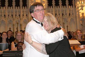 Cormac O’Duffy’s wife Fiona gives him a hug after the successful completion of the premiere of his oratorio, The Wedding Feast of the Lamb.