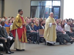 Deacons Joseph George and Stuart Young wait before the altar during their ordination to the priesthood in St Joseph’s Church, Morrinsville, on October 10. Fr George’s brother and father, Ebin and George Arimattathil, and his adopted New Zealand parents, Hanley and Doreen Hoffmann, are seated to Fr Joseph’s right, although only Ebin Arimattathil is visible. Fr George’s mother died this year in India and his father and brother travelled from India for the ordination Mass. Fr Young’s three children are sitting immediately to his left. They are Andrew, Elizabeth and Campbell Young and assisted in the vesting  of the stole and chasuble on their father.