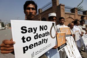Human rights activists hold placards during a rally in early October against the death penalty in Peshawar, Pakistan. (CNS photo/Arshad Arbab, EPA) See POPE-PEACE-MESSAGE Dec. 15, 2015.