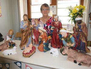 Square Gift Shop manager Sandra Barden with a Nativity scene.