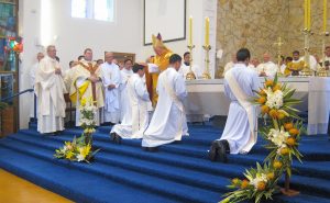 At a key point in the ordination, Bishop Meeking lays his hands on the candidates’ heads.