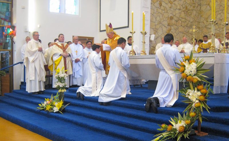 At a key point in the ordination, Bishop Meeking lays his hands on the candidates’ heads.