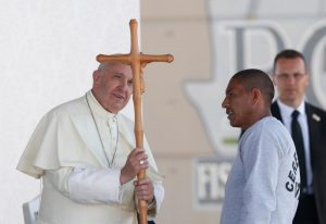 Pope Francis accepts a crucifix from a prisoner as he visits Cereso prison in Ciudad Juarez, Mexico, Feb. 17. (CNS photo/Paul Haring) See POPE-MEXICO-PRISON Feb. 17, 2016.
