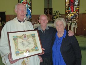 From left: Fr Vincent Jones presents a papal award to Kevin and Kathleen Cantwell at St Pius X Church, Tokoroa.