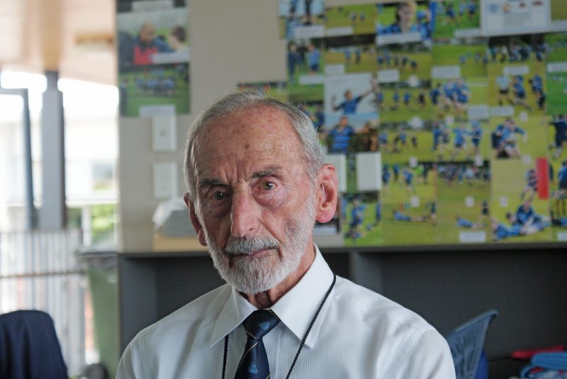 Br Dunstan Henry, 60 years teaching and coaching rugby. Note all the college rugby photos on the wall.