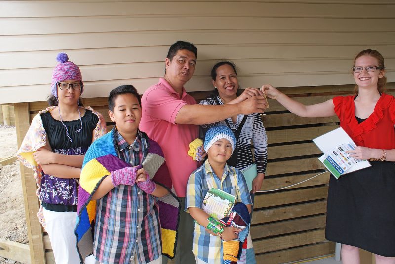 Architect Elke Vermeulen (right) hands the keys of their new house to the
Lao family, from left, Greshka (12), Dhon (10), Armando, Hanz (5), and Geroina.
