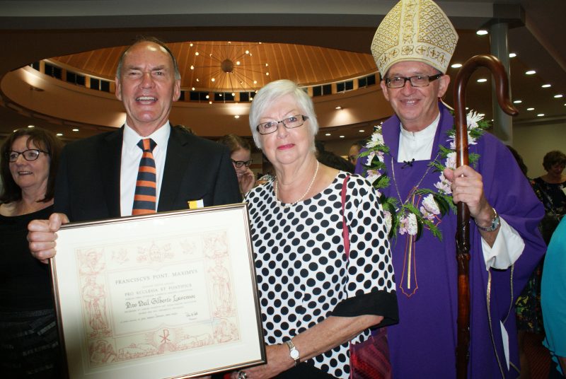 The former manager of the Auckland diocese Catholic Schools Office, Neil Laurenson, holds his papal award, Pro Ecclesia et Pontifice. With him are his wife, Lyn and Bishop Patrick Dunn, Bishop of Auckland.