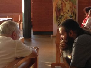Former satanist Zac King, right, who converted to Catholicism after an encounter with the Blessed Mother, talks to Auckland priest Fr Rory Morrissey.