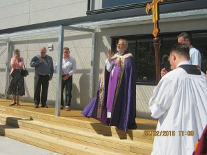 Christchurch diocese administrator Fr Rick Loughnan blesses the new cathedral parish building.