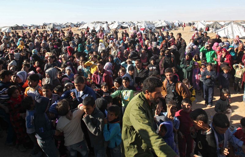 Syrian refugees wait at the border Jan. 13 near Royashed, Jordan. 