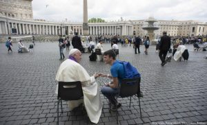Pope Francis hears confession of a youth April 23 in St. Peter's Square at the Vatican. (CNS photo/L'Osservatore Romano via Reuters) See POPE-JUBILEE-TEENS and SULLIVAN-TEEN-JUBILEE April 25, 2016.
