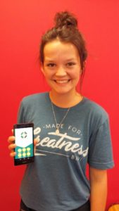 Tauranga parish youth worker Anna-Marie Barrett with the parish app open on her mobile.