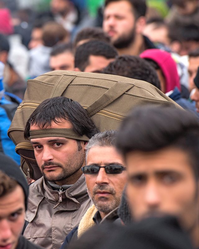 Refugees and migrants from Iraq and Syria wait for permission to leave a registration and transit camp near Gevgelija, Macedonia, on February 24.