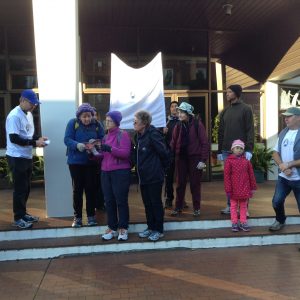 From left to right, hikoi participants Hugh Steel, Carole Hoult, Susan Lloyd, Kathleen Emmerson, Nicholas Bennett, Geraldine Sims, Nigel and Chelsea Bennett with Mike Williams, on the steps into the chapel at St Pat’s, Silverstream.