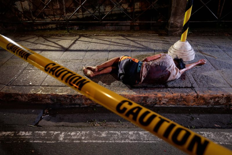 A man allegedly involved in drug dealing or usage lies lifeless on a street after being shot down by an unidentified gunman in 2016 in Manila, Philippines. Expressing concern about thousands of deaths in the nation's so-called "war on drugs," the president of the Philippine bishops' conference has sought courage from a deceased cardinal whose influence helped overthrow a dictator in the mid-1980s. (CNS photo/Mark R, Cristino, EPA) See PHILIPPINES-VILLEGAS-SIN Feb. 27, 2017.