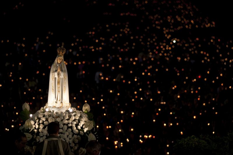 A statue of Mary is carried through the crowd in 2013 at the Marian shrine of Fatima in central Portugal. (CNS photo/Paulo Cunha, EPA) See FATIMA-APPARITIONS April 18, 2017.