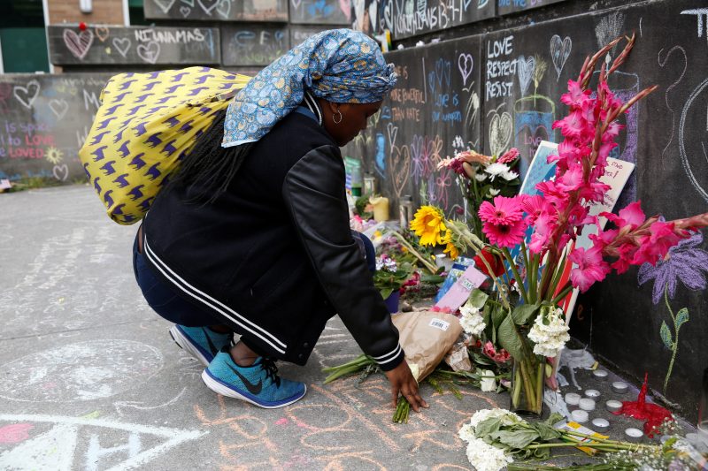 A Muslim woman prays at a makeshift memorial May 29 in Portland, Ore., for two men who were killed May 26 on a commuter train while they were trying to defend two young women from a man yelling racial epithets at them aboard a commuter train, said Portland Mayor Ted Wheeler. Rick Best, a 53-year-old member of Christ the King Parish in Milwaukie, Ore., was one of the victims. (CNS photo/Terray Sylvester, Reuters) See COMMUTER-TRAIN-KILLING May 30, 2017.