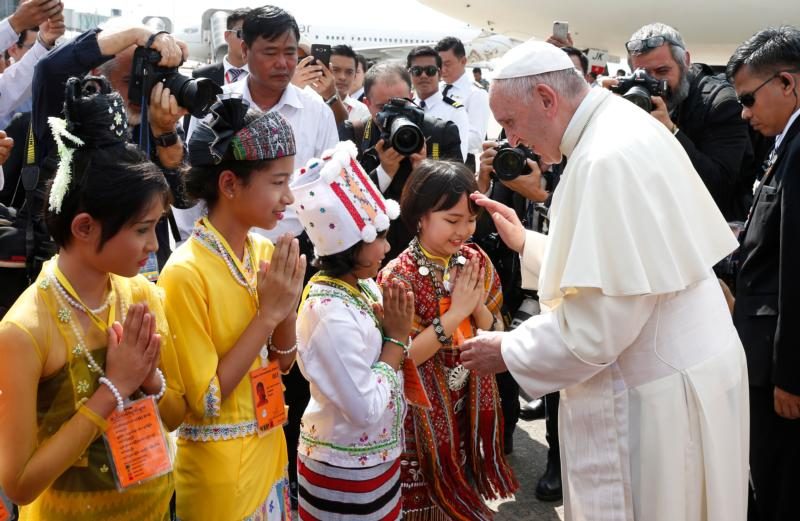 Pope Francis greets children as he arrives at Yangon International Airport in Yangon, Myanmar, Nov. 27. The pope is making a six-day visit to Myanmar and Bangladesh. (CNS photo/Paul Haring) See POPE-MYANMAR-ARRIVE Nov. 27, 2017.