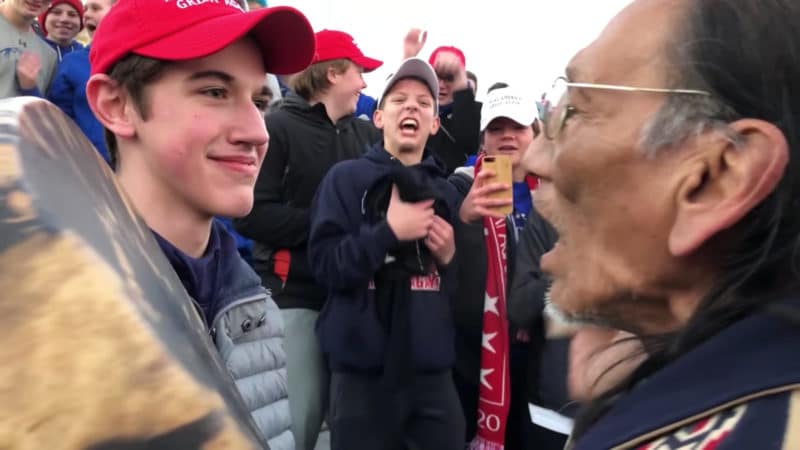 Students from Covington Catholic High School in Park Hills, Ky., stands in front of Native American Vietnam veteran Nathan Phillips Jan. 18 near the Lincoln Memorial in Washington in this still image from video. An exchange between the students and Phillips Jan. 18 was vilified on social media the following day, but the immediate accusations the students showed racist behavior were stepped back as more details of the entire situation emerged. (CNS photo/Kaya Taitano, social media via Reuters) See MARCH-TEENS-REACTION Jan. 21, 2019.