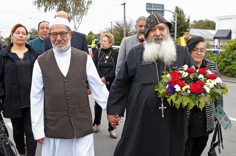 Imam Ibrahim Abdul Halim of New Zealand's Linwood Mosque holds hands with Father Felimoun El-Baramoussy of the Dunedin Coptic Church, as they walk near the mosque in Christchurch March 18, 2019. Prayer services are being held across the country and abroad after two mosque attacks in Christchurch March 15 that left at least 50 people dead and 20 seriously injured. (CNS photo/Edgar Su, Reuters) See NEW-ZEALAND-MOSQUE-PRAYER March 18, 2019.  REUTERS/Edgar Su
