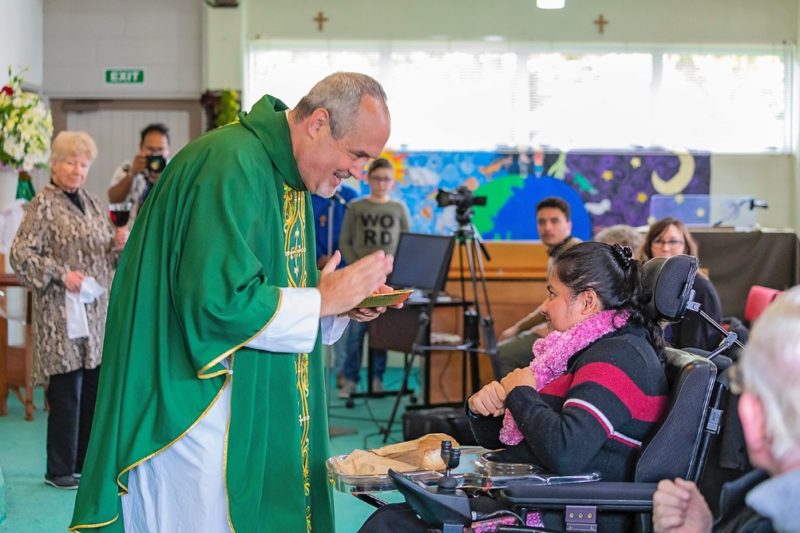 Fr Michael Depcik, OSFS, with Prakashni Prakash at the Mass at Blockhouse Bay. (Photo:
Anna Dubbelt).